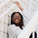 a woman leaning on a railing