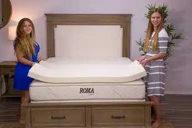 2 women showing a latex mattress topper