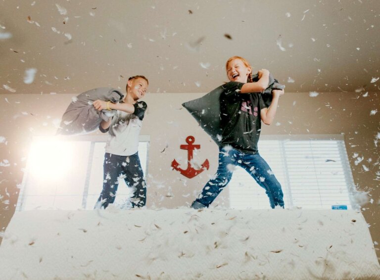 two kids have a pillow fight