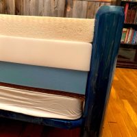 an unzipped DIY mattress on a bed showing the different comfort and support layers