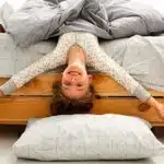 smiling playful girl enjoying a vegan and organic mattress