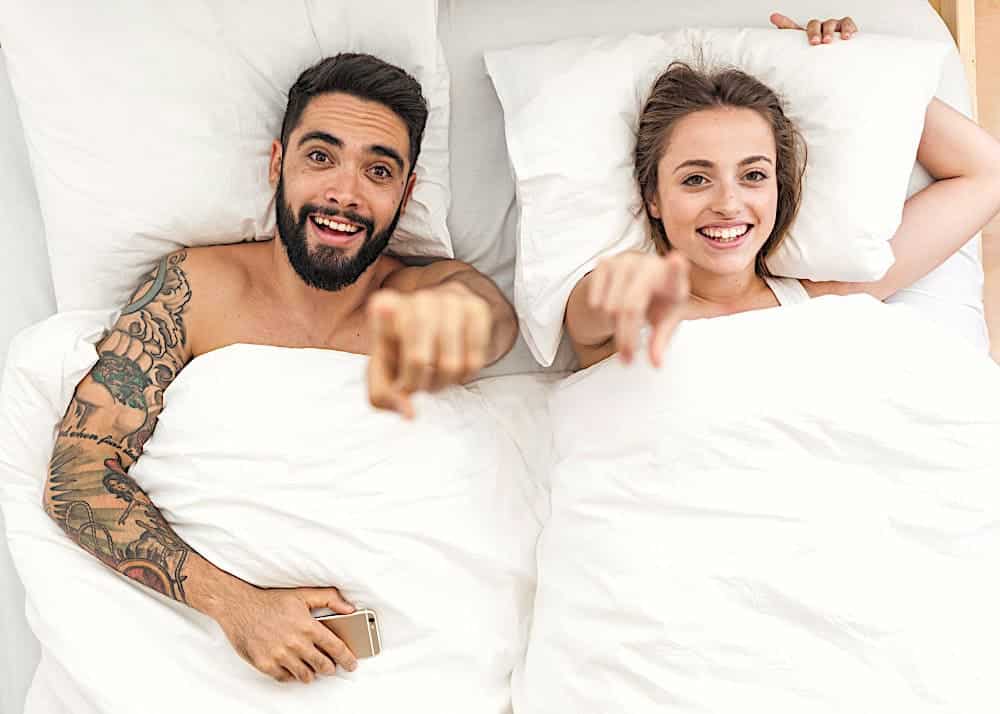 Couple in bed who love their DIY mattress