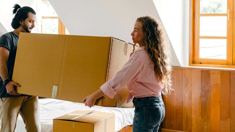 a woman holding a large box