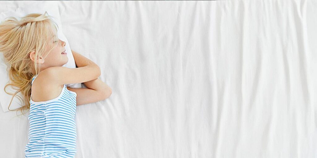 young girl sleeping on her organic diy child's mattress