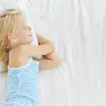 young girl sleeping on her organic diy child's mattress