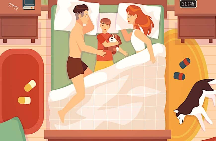 a man and woman lying in bed with a baby and a dog