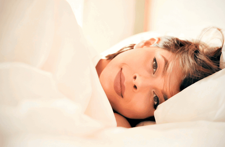 Person resting on a bed.