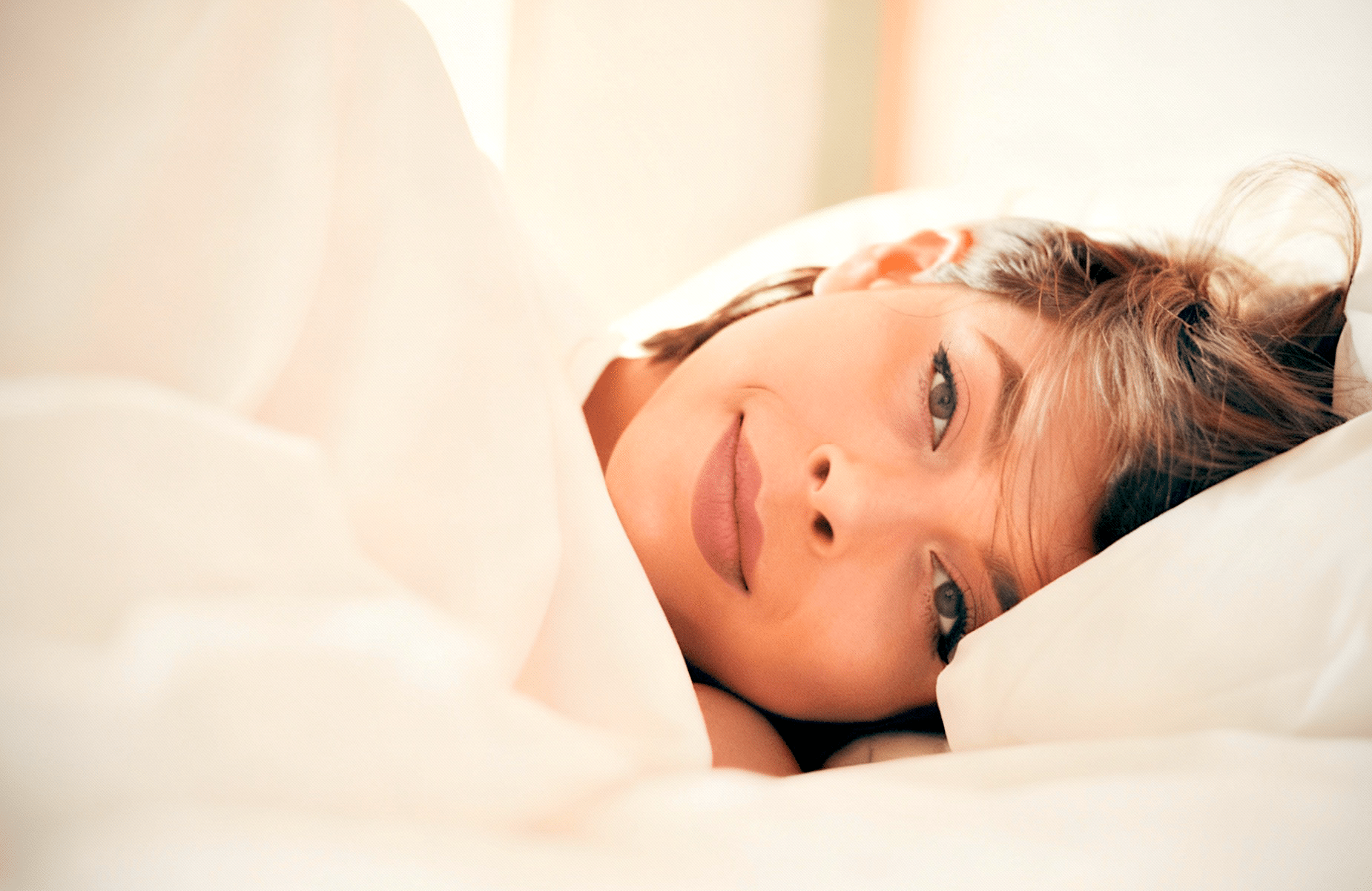 Person resting on a bed.